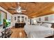 Bright bedroom featuring vaulted wood ceiling, hardwood floors, and a flatscreen TV at 3152 Sycamore Ln, Marietta, GA 30066