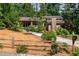 Charming home featuring a stone chimney, lush landscaping, and a welcoming driveway at 3152 Sycamore Ln, Marietta, GA 30066