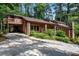 Exterior of home showcasing attached garage, stone accents, and a long driveway at 3152 Sycamore Ln, Marietta, GA 30066