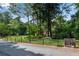 Well-manicured front yard featuring a split-rail fence and mature trees for privacy at 3152 Sycamore Ln, Marietta, GA 30066