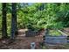 A beautiful view of raised garden beds with various plants nestled in a wooded backyard at 3152 Sycamore Ln, Marietta, GA 30066
