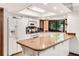 Well-lit kitchen featuring white appliances, granite countertops, and ample natural light at 3152 Sycamore Ln, Marietta, GA 30066