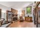 Cozy living room featuring a stone fireplace, hardwood floors, and large windows at 3152 Sycamore Ln, Marietta, GA 30066