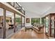 Open-concept living room with hardwood floors, a stone fireplace, and dining area at 3152 Sycamore Ln, Marietta, GA 30066