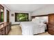 Bright main bedroom with a large window and dark wood furniture at 3152 Sycamore Ln, Marietta, GA 30066