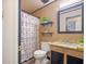 Bathroom featuring a large mirror, granite vanity, and a shower with unique tile at 5841 Cobalt Dr, Powder Springs, GA 30127