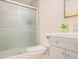 Cozy bathroom featuring a tiled shower, gray cabinets, and decorative accents at 5841 Cobalt Dr, Powder Springs, GA 30127