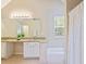 Bright bathroom featuring a large vanity, soaking tub with shower, and neutral tile floors at 5841 Cobalt Dr, Powder Springs, GA 30127