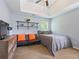 Bedroom with high ceilings and a ceiling fan, mounted shelves and neutral colors at 5841 Cobalt Dr, Powder Springs, GA 30127