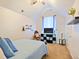 Cozy bedroom with a ceiling fan, mounted shelves, and natural light at 5841 Cobalt Dr, Powder Springs, GA 30127