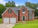 Charming brick home with a well-manicured lawn and a two-car garage at 5841 Cobalt Dr, Powder Springs, GA 30127