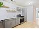 Updated kitchen featuring stainless steel appliances, white subway tile backsplash, and light wood grain flooring at 5841 Cobalt Dr, Powder Springs, GA 30127