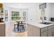 Eat-in kitchen area with bright natural light, barstool seating, and stainless steel sink at 5841 Cobalt Dr, Powder Springs, GA 30127