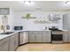 Updated kitchen featuring stainless steel appliances, white subway tile backsplash, and light wood grain flooring at 5841 Cobalt Dr, Powder Springs, GA 30127