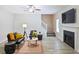 Cozy living room featuring fireplace, ceiling fan, staircase and neutral color scheme at 5841 Cobalt Dr, Powder Springs, GA 30127
