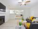 Open concept living room featuring fireplace, ceiling fan, and view into the kitchen at 5841 Cobalt Dr, Powder Springs, GA 30127