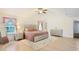 Bright main bedroom with light wood floors, ceiling fan, and a sitting area with a soft area rug at 5841 Cobalt Dr, Powder Springs, GA 30127