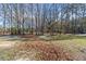 Spacious backyard with mature trees and natural foliage creates a serene outdoor setting at 900 Stone Lea Trce, Oxford, GA 30054