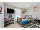 Comfortable bedroom with a twin bed, TV, wooden floor, and fun superhero and Minion decor at 900 Stone Lea Trce, Oxford, GA 30054