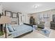 Bright bedroom featuring a blue bedspread and a sitting area near the windows at 900 Stone Lea Trce, Oxford, GA 30054
