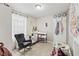 Bright Bedroom room featuring a gray rocker, crib, changing table, and decor at 900 Stone Lea Trce, Oxford, GA 30054
