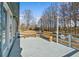 View of the home's wood deck with wood benches and light-blue painted railings at 900 Stone Lea Trce, Oxford, GA 30054
