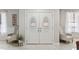 Elegant double front doors with decorative glass inserts and seating for guests at 900 Stone Lea Trce, Oxford, GA 30054