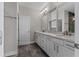 Modern bathroom with double vanity, granite countertops, and sleek fixtures at 2118 Iverson Se Dr, Smyrna, GA 30080