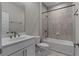 Modern bathroom featuring a white vanity, toilet, and tiled shower-over-tub at 2118 Iverson Se Dr, Smyrna, GA 30080