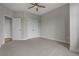 Large carpeted bedroom with a ceiling fan and closet space at 2118 Iverson Se Dr, Smyrna, GA 30080