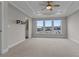 Bright bedroom featuring a ceiling fan, with view through the windows of neighboring homes at 2118 Iverson Se Dr, Smyrna, GA 30080