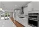 Well-equipped kitchen with stainless steel appliances, white cabinets, quartz countertops, and modern fixtures at 2118 Iverson Se Dr, Smyrna, GA 30080