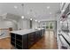 Kitchen with sleek island, stainless appliances, hardwood floors, modern lighting, and open concept layout at 2118 Iverson Se Dr, Smyrna, GA 30080