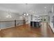 Open kitchen and living area boasts hardwood floors, large island, modern lighting, and stainless appliances at 2118 Iverson Se Dr, Smyrna, GA 30080