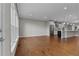 Open-concept living room with hardwood floors and a kitchen area featuring stainless steel appliances at 2118 Iverson Se Dr, Smyrna, GA 30080