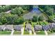 Birds-eye view of house, next to pond, with large front lawn and driveway and neighborhood at 2875 Daniel Park Run, Dacula, GA 30019