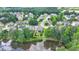 Aerial view of home with backyard adjacent to a serene lake, surrounded by mature trees and lush landscaping at 2875 Daniel Park Run, Dacula, GA 30019