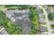 Aerial view of home backing to lake, reflecting sky, with a lushly wooded perimeter at 2875 Daniel Park Run, Dacula, GA 30019