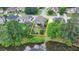 Large backyard of home that sits on a pond, with a raised deck, play set, and mature trees at 2875 Daniel Park Run, Dacula, GA 30019