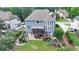 Aerial view of backyard with a raised porch, mature trees, a slide, and a large well-kept lawn at 2875 Daniel Park Run, Dacula, GA 30019