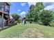 Backyard featuring a playset with a slide, green lawn, and mature trees at 2875 Daniel Park Run, Dacula, GA 30019