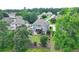Backyard with raised porch, mature trees, and play set of a house located in a community on a pond at 2875 Daniel Park Run, Dacula, GA 30019