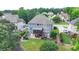 Aerial view of backyard with a raised porch, mature trees, and play set of a house located in a community at 2875 Daniel Park Run, Dacula, GA 30019
