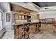 Finished basement bar features wood cabinetry, a sink, glass shelving, and tile flooring at 2875 Daniel Park Run, Dacula, GA 30019