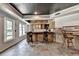 Finished basement bar area with light wood cabinets, tile flooring, and built-in lighting at 2875 Daniel Park Run, Dacula, GA 30019