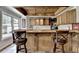 Finished basement bar with a sink, wood cabinetry, overhead lighting, and counter seating at 2875 Daniel Park Run, Dacula, GA 30019