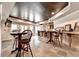Finished basement features a rustic bar area with custom wood details and stone tile floors at 2875 Daniel Park Run, Dacula, GA 30019