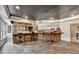 Finished basement bar with wood cabinetry, countertop seating, and an open floor plan at 2875 Daniel Park Run, Dacula, GA 30019