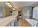 Spacious bathroom with double vanity, large mirror, and soaking tub at 2875 Daniel Park Run, Dacula, GA 30019