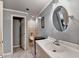 Powder bathroom with a pedestal sink, oval mirror, and open door at 2875 Daniel Park Run, Dacula, GA 30019